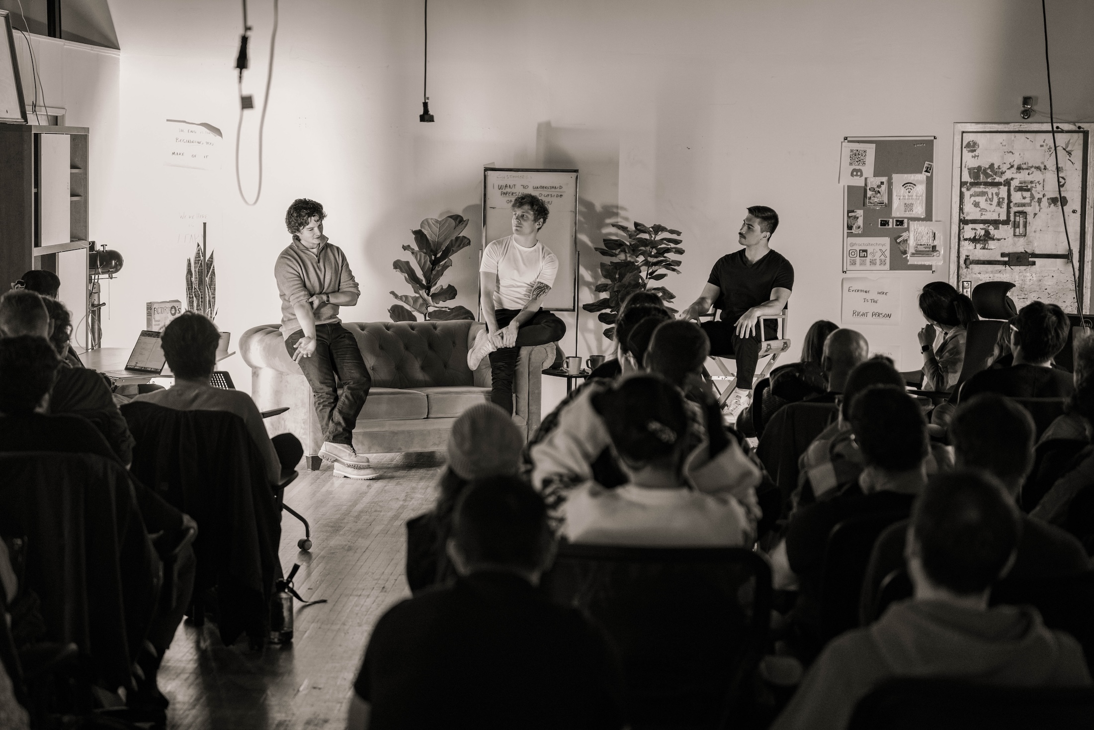 Anthony leaning on a couch while speaking to a room at Fractal Tech